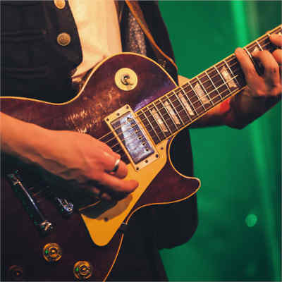 Guitar lessons. Close up of guitar as person is playing it