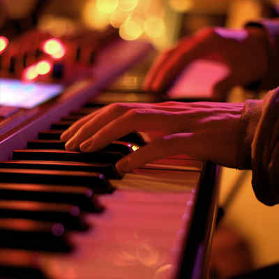 Keyboard and Piano Lessons. Close up of hands paying a keyboard.